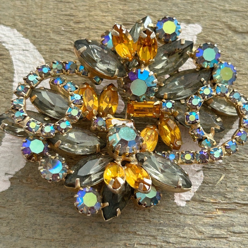 Elegant Gold and Silver Brooch with Blue and Orange Accents